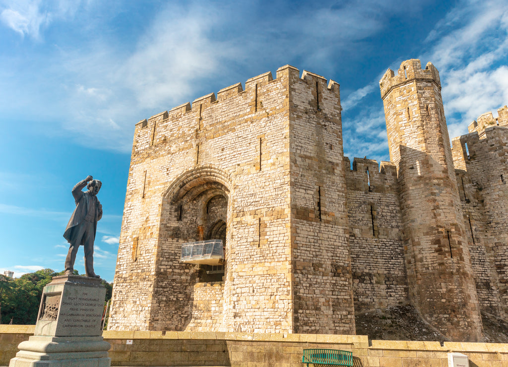 Caernarfon Castle in North Wales with bronze statue of David Lloyd George Prime Minister of the United Kingdom, 1916-22