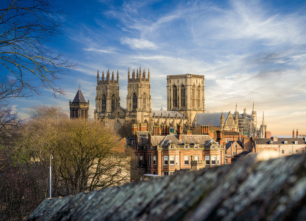York Minster Cathedral with blue sky sunshine and castle walls