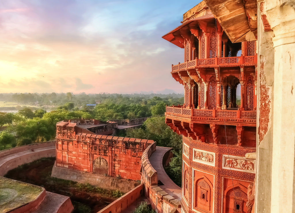 Agra Fort - Famous medieval historic fort exterior structure with view of Agra city landscape at sunrise