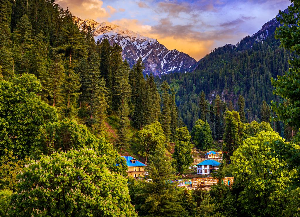 Landscape in the mountains. Scenic golden hour view in the Himalaya range. Sunrise view from the dense forest of Himalayan village Grahan, Kasol, Himachal Pradesh, India