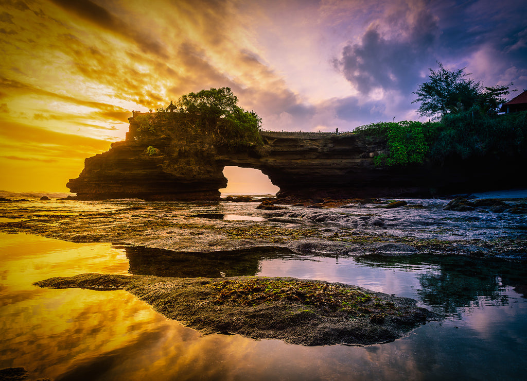 Tanah Lot Temple on sea at sunset in Bali Island, Indonesia