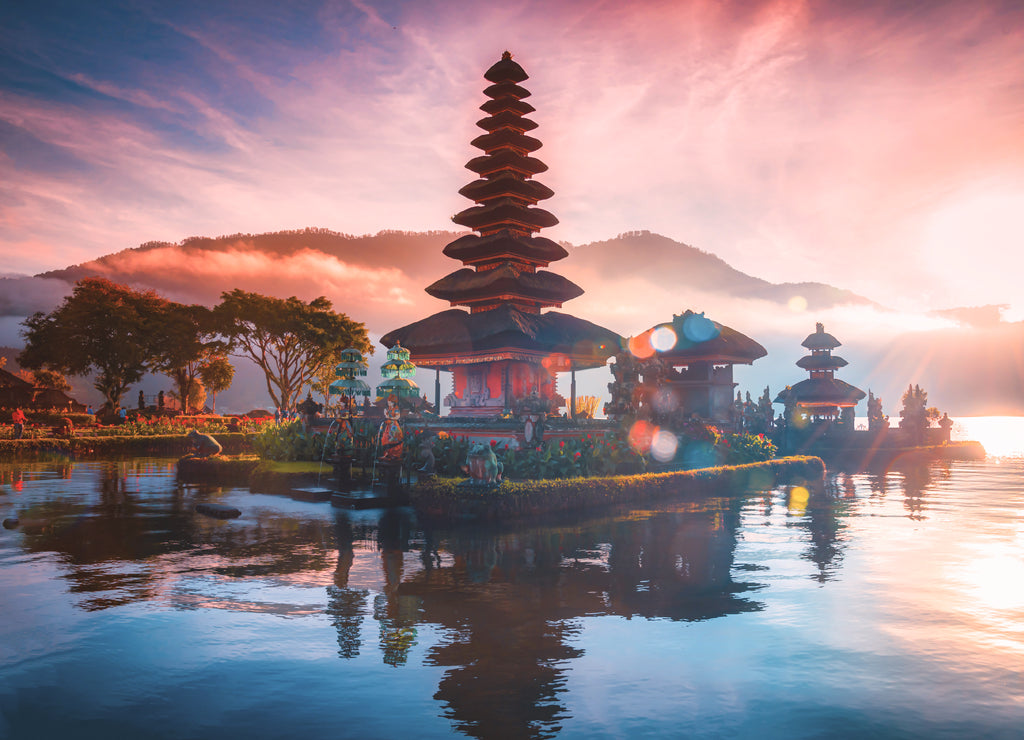 Pura Ulun Danu Bratan, Hindu temple on Bratan lake landscape with lens flare at sunrise in Bali, Indonesia