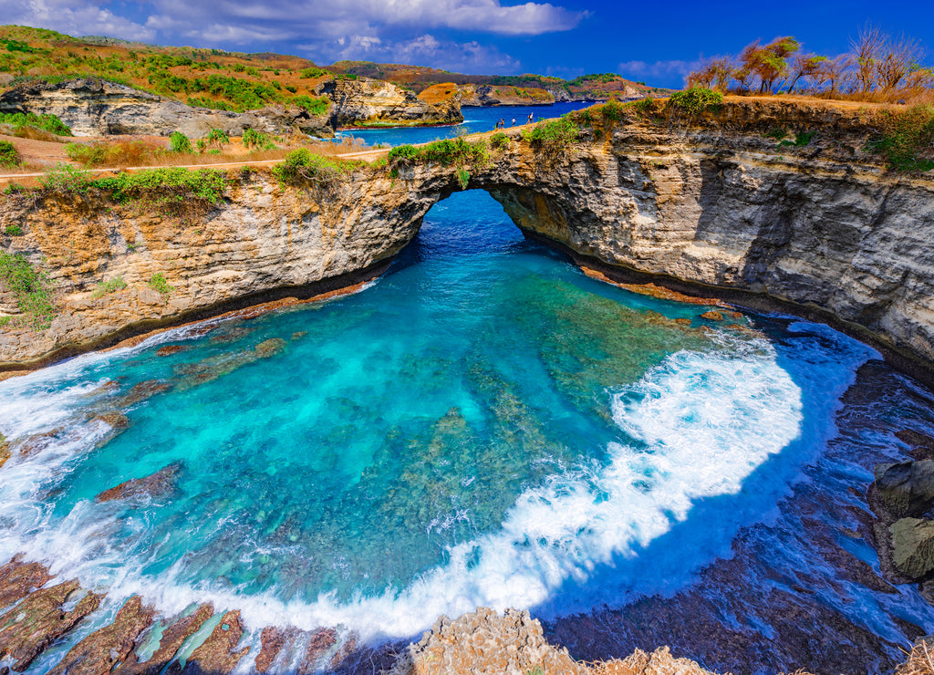 Broken beach and Billabong beach rocky bay with sky blue ocean water and blue sky, eastern in Nusa Penida island, Bali Island, Indonesia