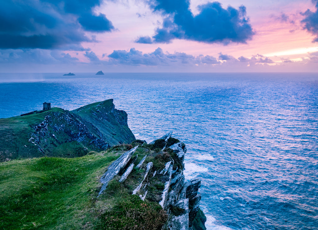 A viewpoint from Bray Head on Valentia island in the ring of Kerry in the south west coast of Ireland during an autumn sunset showing the Skellig islands and watchtower