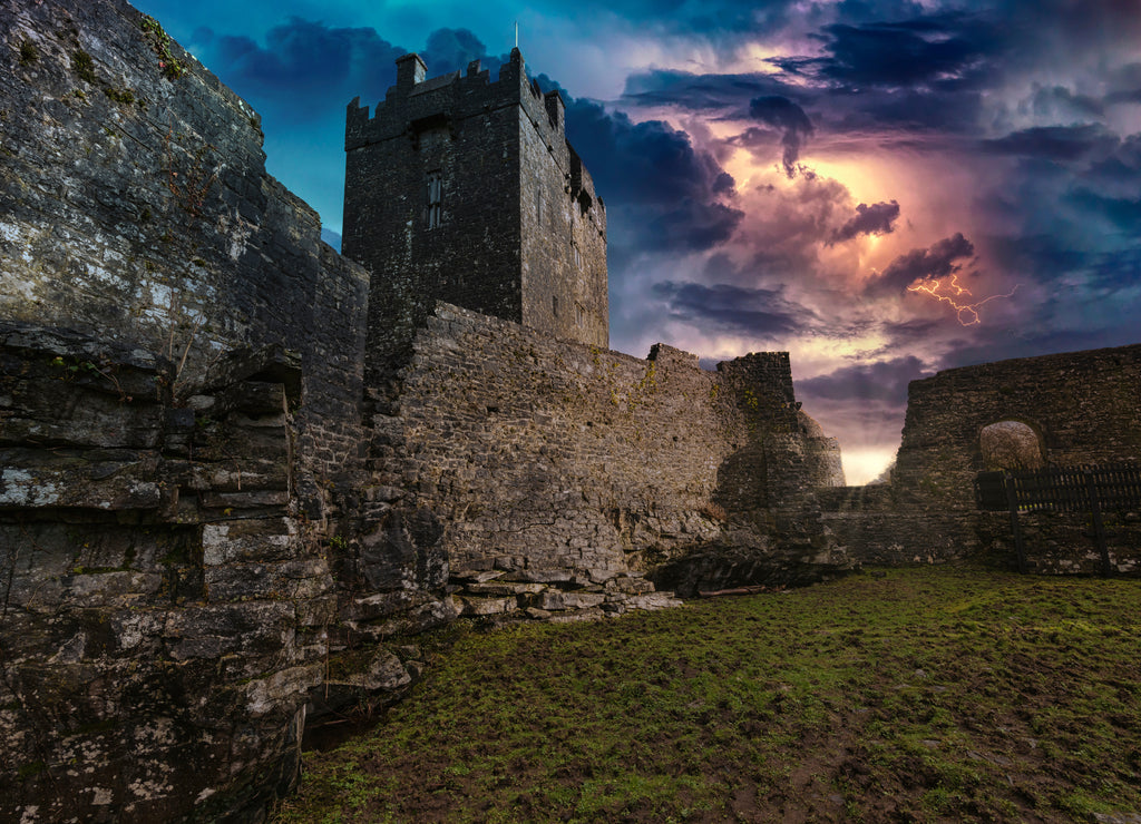 An ancient old castle in Ireland with a storm and lightning landscape