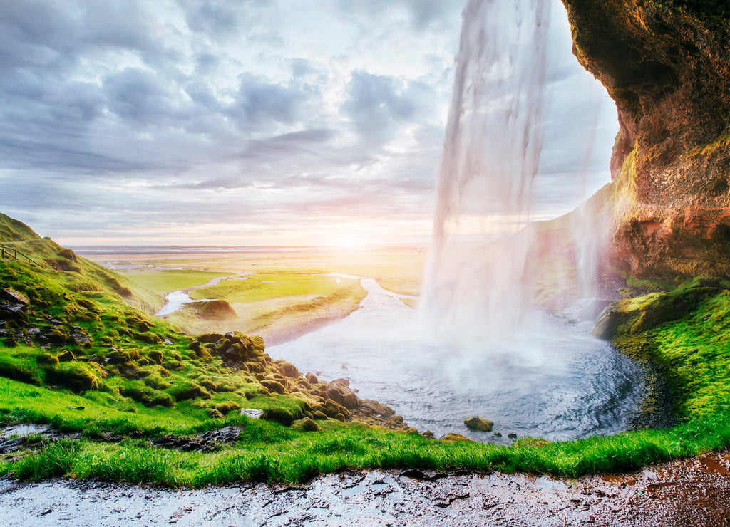 Seljalandfoss waterfall at sunset. Bridge over the river. Fantastic nature. Iceland