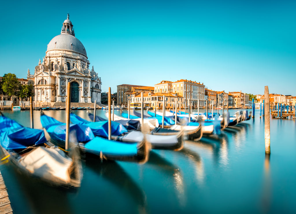 Venice cityscape view on Santa Maria della Salute basilica with gondolas on the Grand canal in Venice