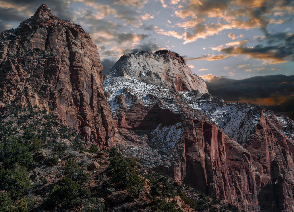 Mountains and cliffs and rock formations covered in snow along the scenic floor drive in Zion National Park, Springdale, Utah, USA