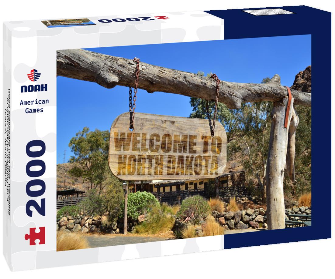 Noah Jigsaw Puzzle wood signboard with text " welcome to north dakota" hanging on a branch, North Dakota 2000 pieces