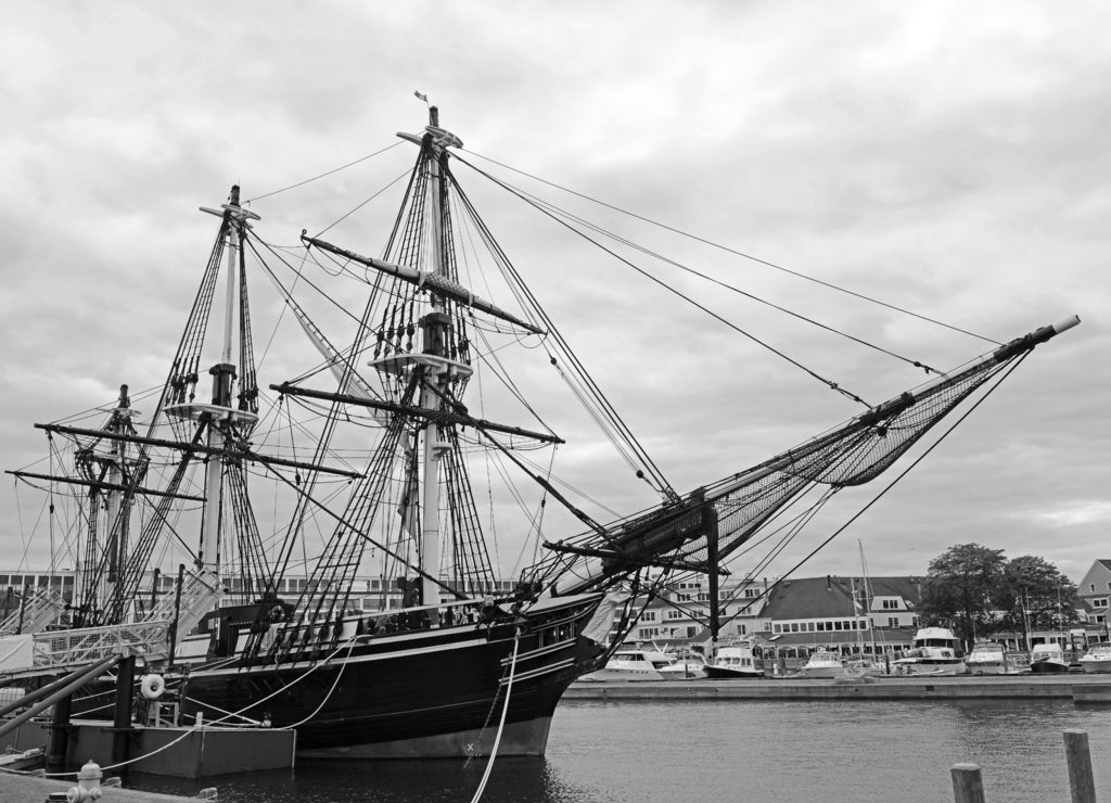 Antique ship Friendship of Salem docked at a pier in the Salem Maritime National Historic Site, Salem Massachusetts in black white