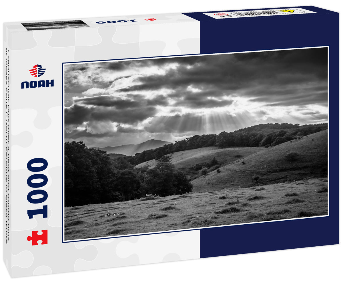 Crepuscular rays over a field and rolling hills at Moses Cone P North Carolina in black white