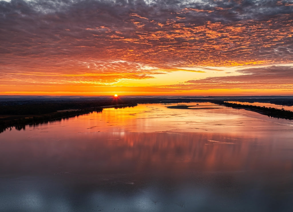 Sunrise over the Tennessee River with beautiful colorful orange sky. Wheeler Wildlife Refuge in Decatur Alabama USA