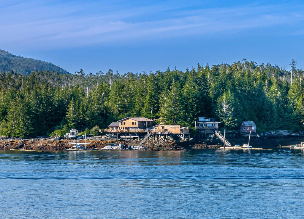 Ketchikan, Alaska, USA: Blue sky and blue water separated by green forested belt with a few buildings along shoreline
