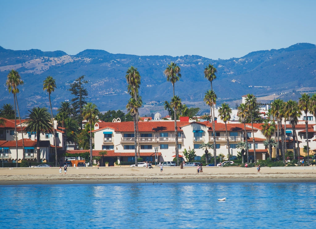 Beautiful view of Santa Barbara ocean front walk, with beach and marina, palms and mountains, Santa Ynez mountains and Pacific Ocean, Santa Barbara county, California, United States, summer sunny day