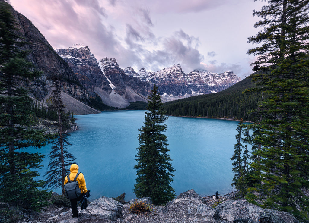 Traveler standing on Moraine lake with Canadian rockies in Banff national park