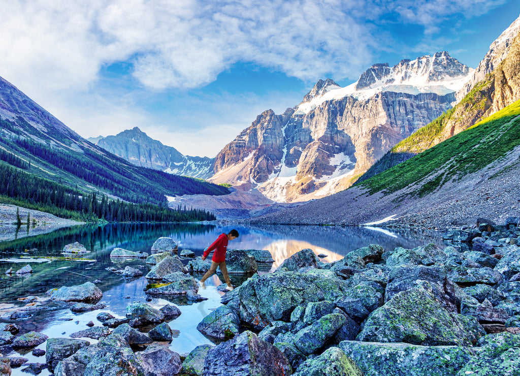 Boy Hiker Rock Hopping Across Consolation Lake in Banff National Park near Moraine Lake in the Vicinity of Lake Louise, Alberta