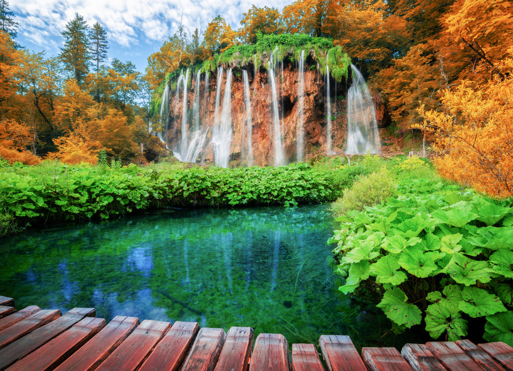 Beautiful wooden path trail for nature trekking with lakes and waterfall landscape in Plitvice Lakes National Park, UNESCO natural world heritage and famous travel destination of Croatia