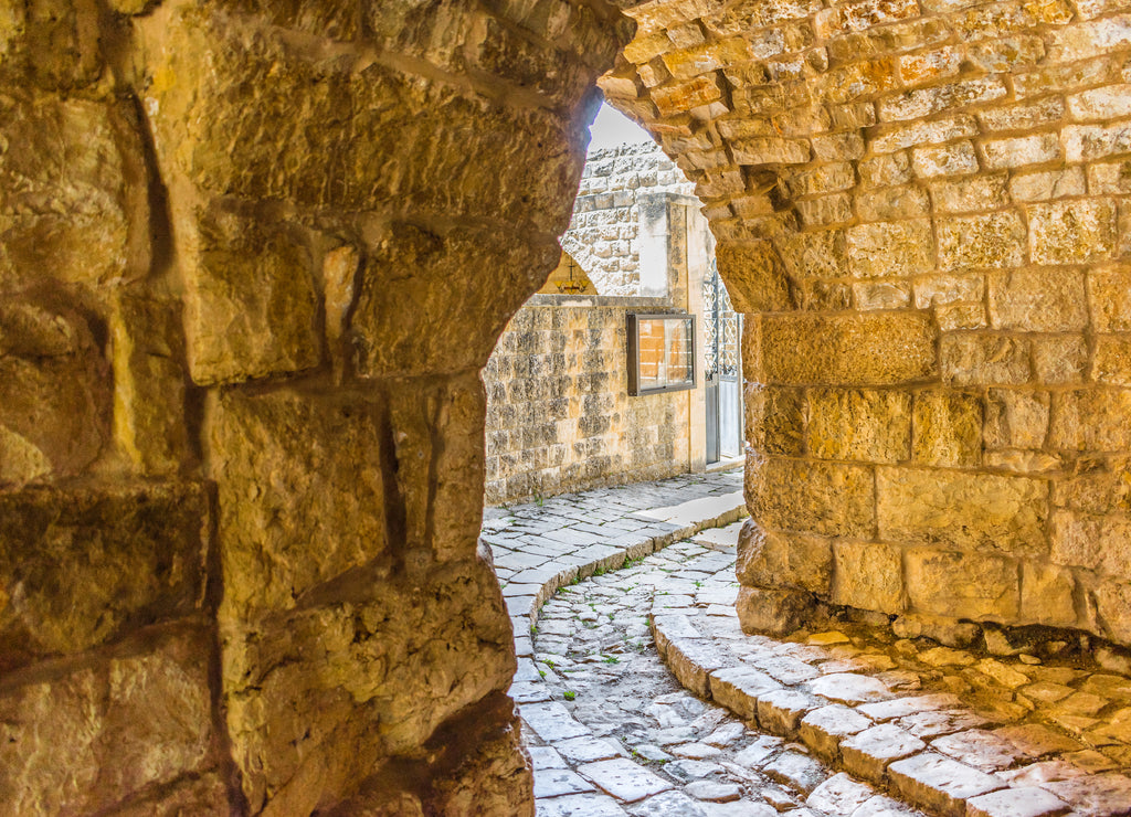 This is a capture of the old roads in Der El Kamar a village Located in Lebanon and you can see in the picture the old walk made of stones with an historic architecture for walls and houses