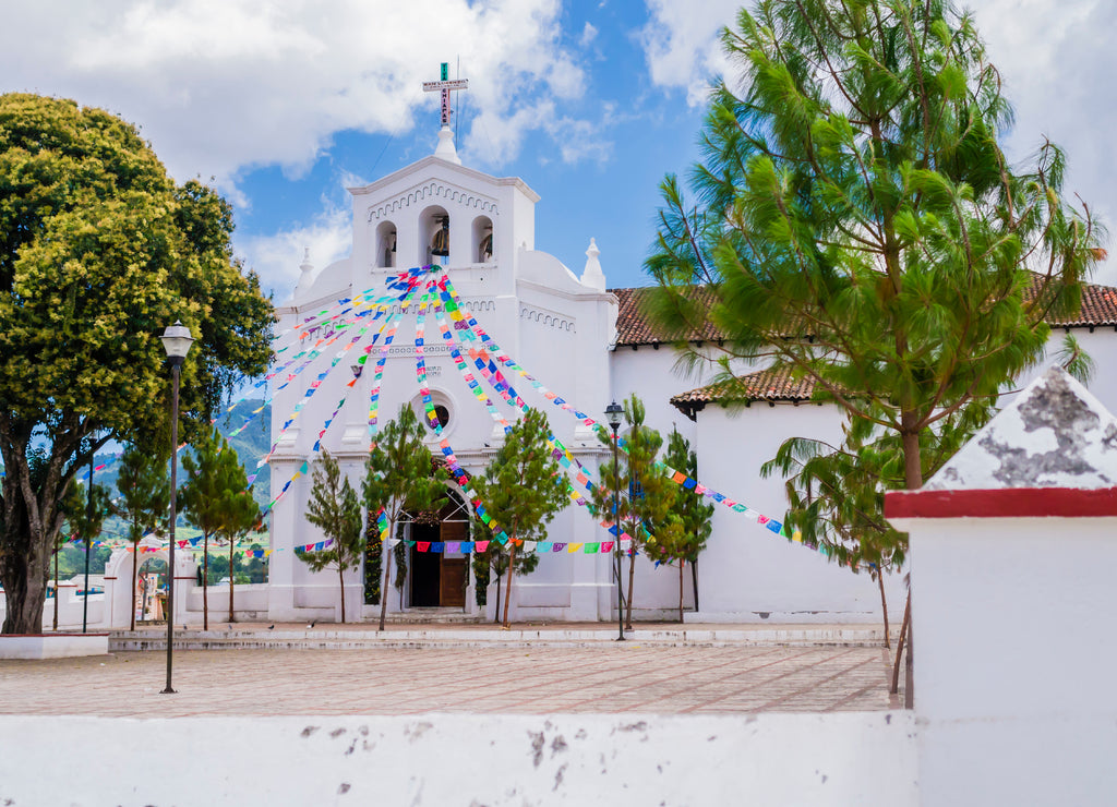 Impressive view of San Lorenzo church and its parvis with colorful prayer flags , Zinacantan, Chiapas, Mexico