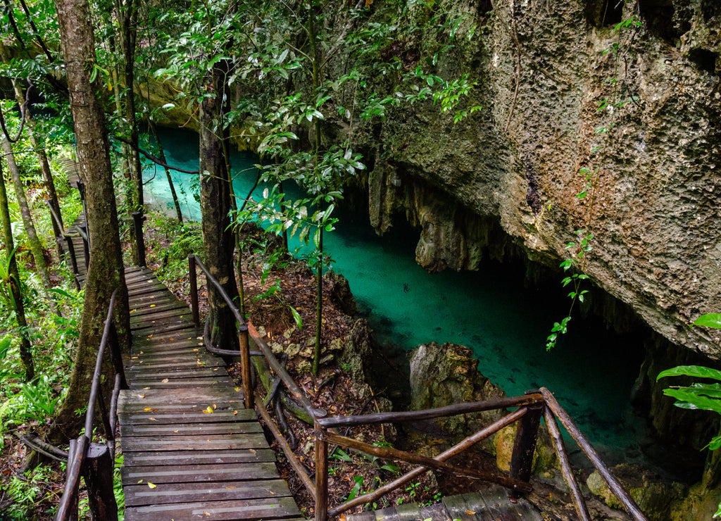 wooden pathway in cenote with crystal clear fresh water near Tulum - Riviera Maya, Tulum, Yucatan, Mexico