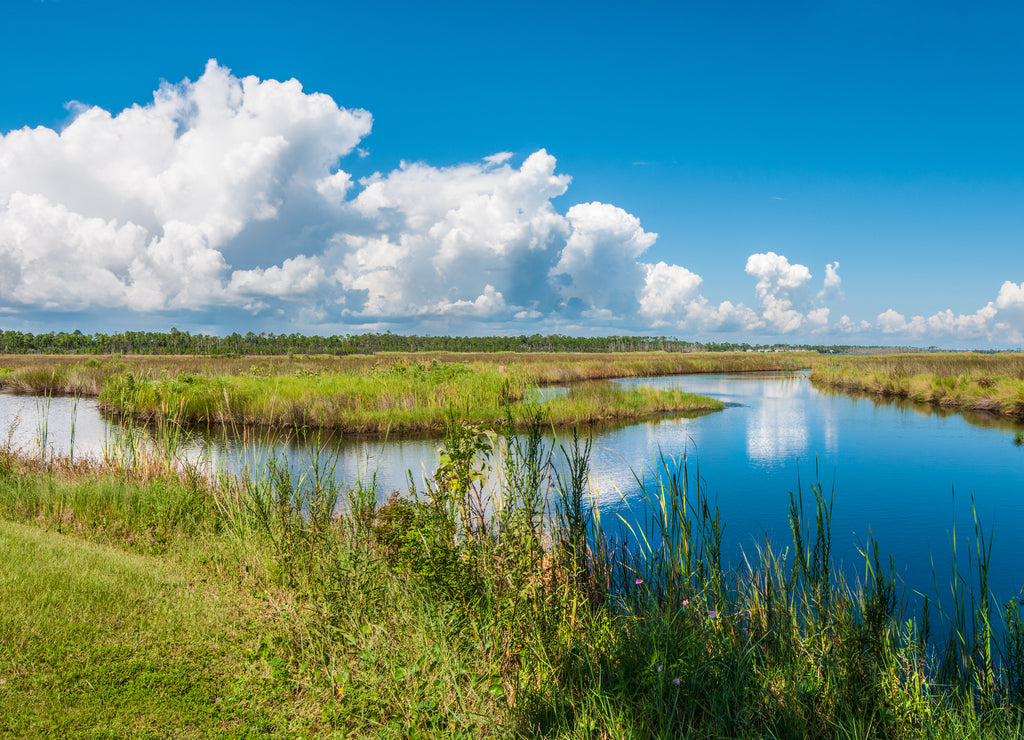 Panorama of canals in Gulf Shores State Park in Alabama USA with reflections of sky on water