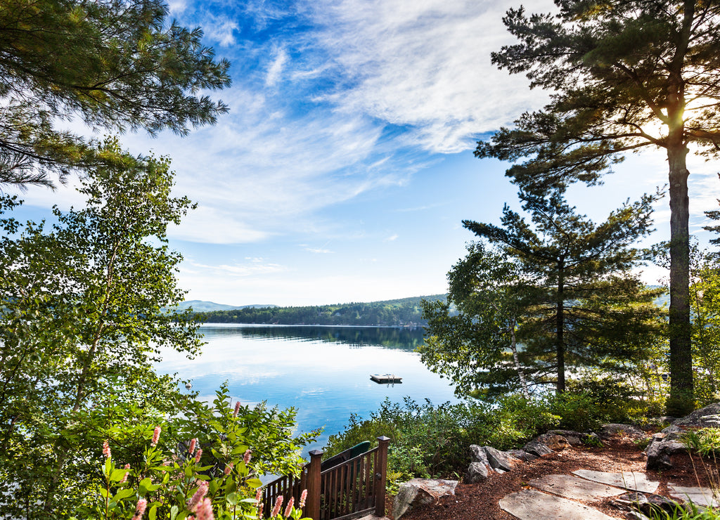 Merrymeeting Lake with early morning sun peeking through the trees, New Hampshire