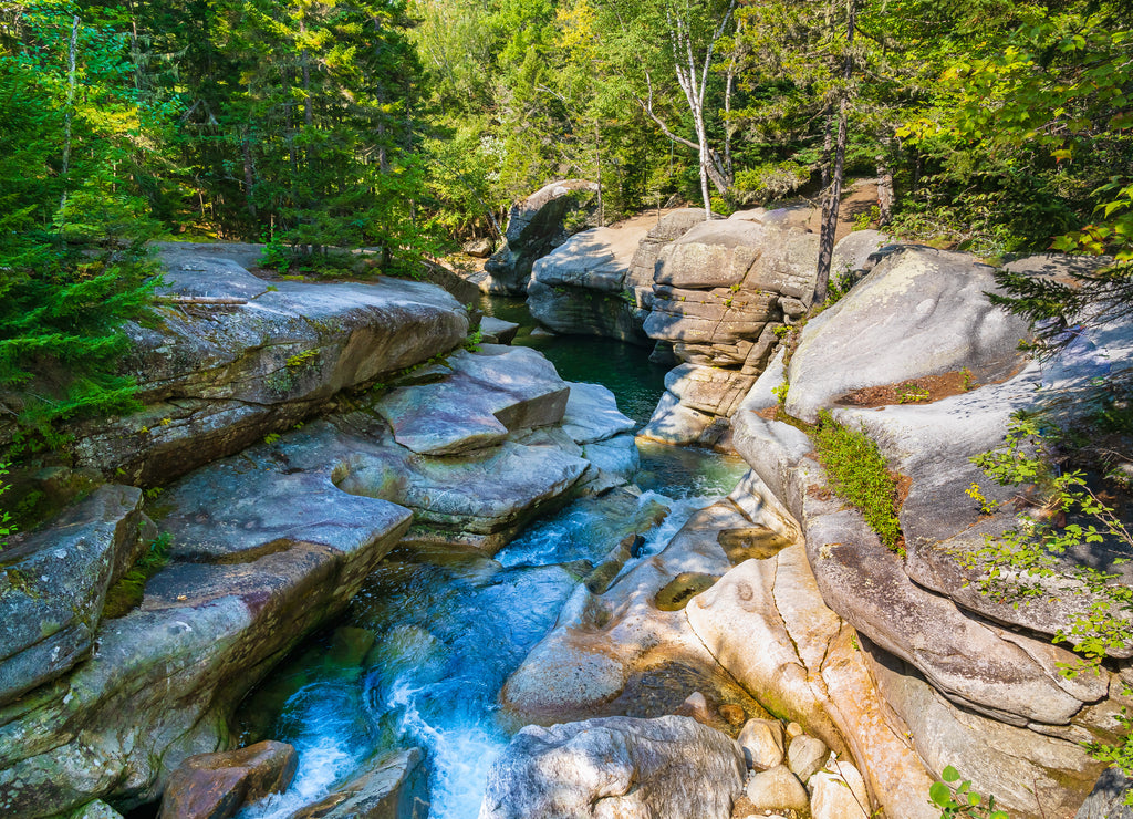 The Ammonoosuc river in a canyon among granite stones in the forest, flowing from Mount Washington in the White Mountain National Forest in New Hampshire