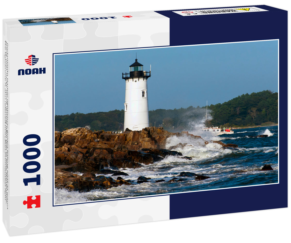 Portsmouth Harbor lighthouse guides fishing boat as waves break over rocky shore during high tide in New Hampshire. The lighthouse is also referred to as Fort Constitution light