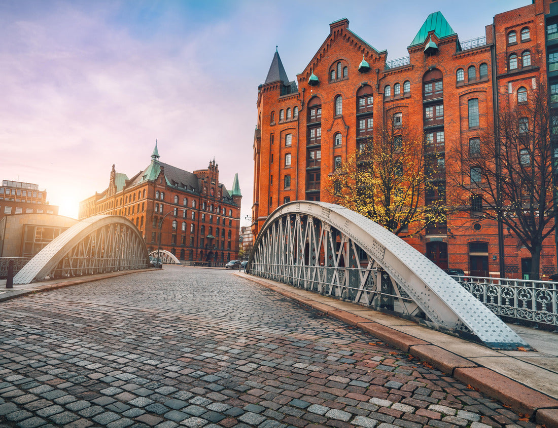Noah Jigsaw Puzzle Arch bridge over alster canals with cobbled road in historical Speicherstadt of Hamburg, Germany, Europe. Scenic view of red brick building lit by golden sunset light 1000 pieces
