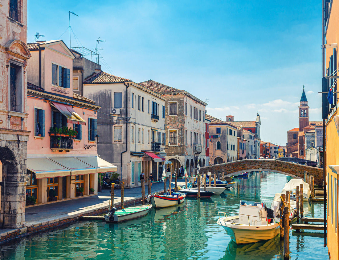 Noah Jigsaw Puzzle Chioggia cityscape with narrow water channel Vena with colorful boats between old buildings and brick bridge, blue sky background in summer, Veneto region, northern Italy 1000 pieces