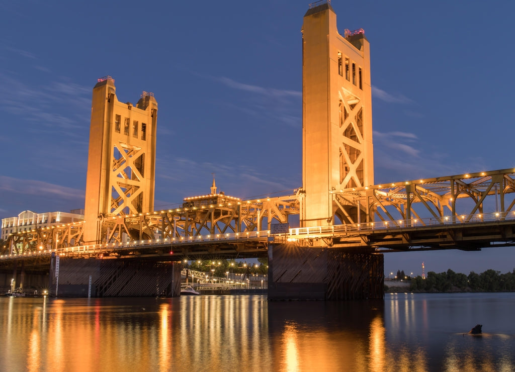 Tower Bridge and lights reflected on the Sacramento River. Sacramento and Yolo Counties, California, USA