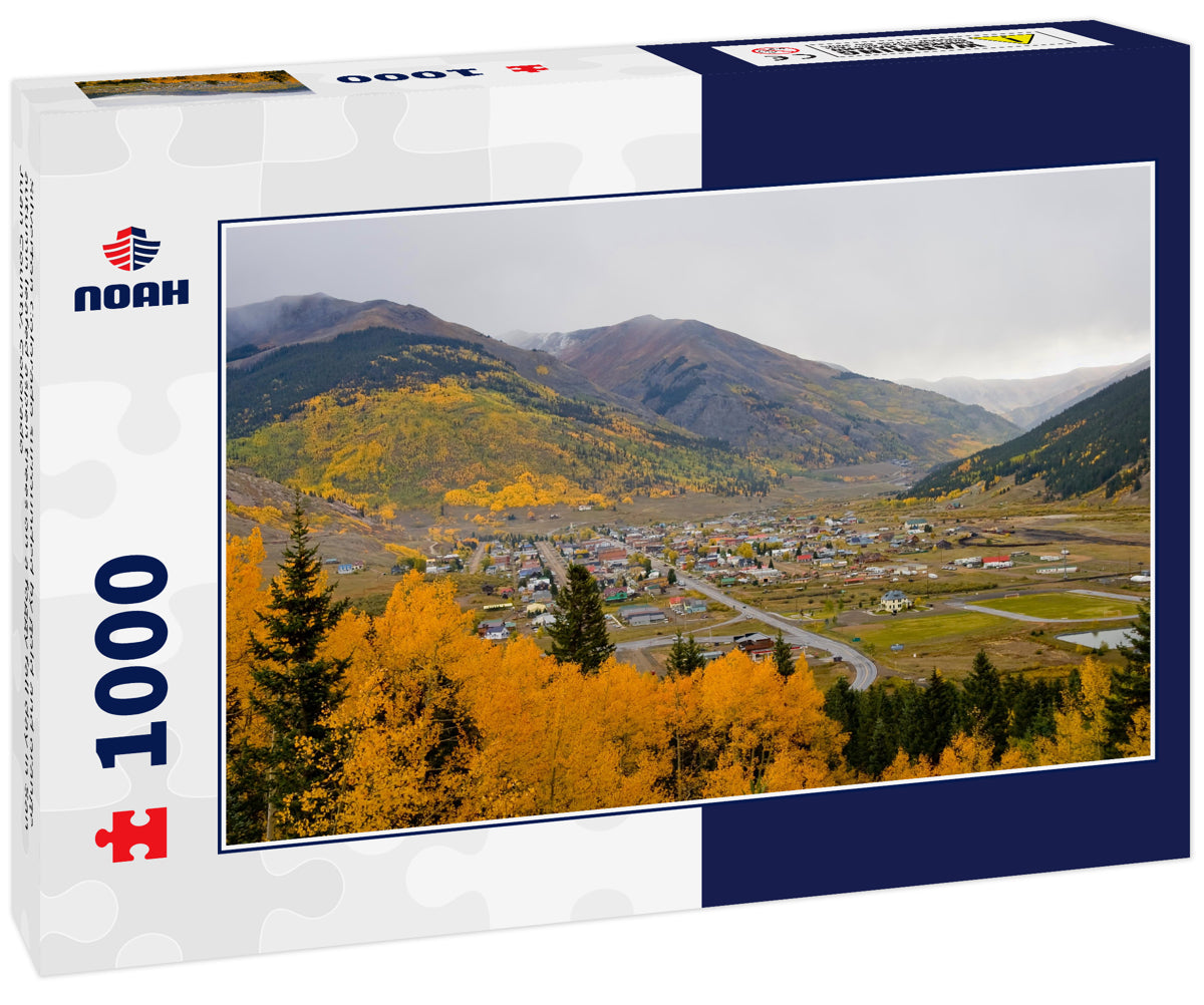 Silverton Colorado surrounded by gold and orange autumn leafed aspen trees on a foggy fall day in San Juan County, Colorado
