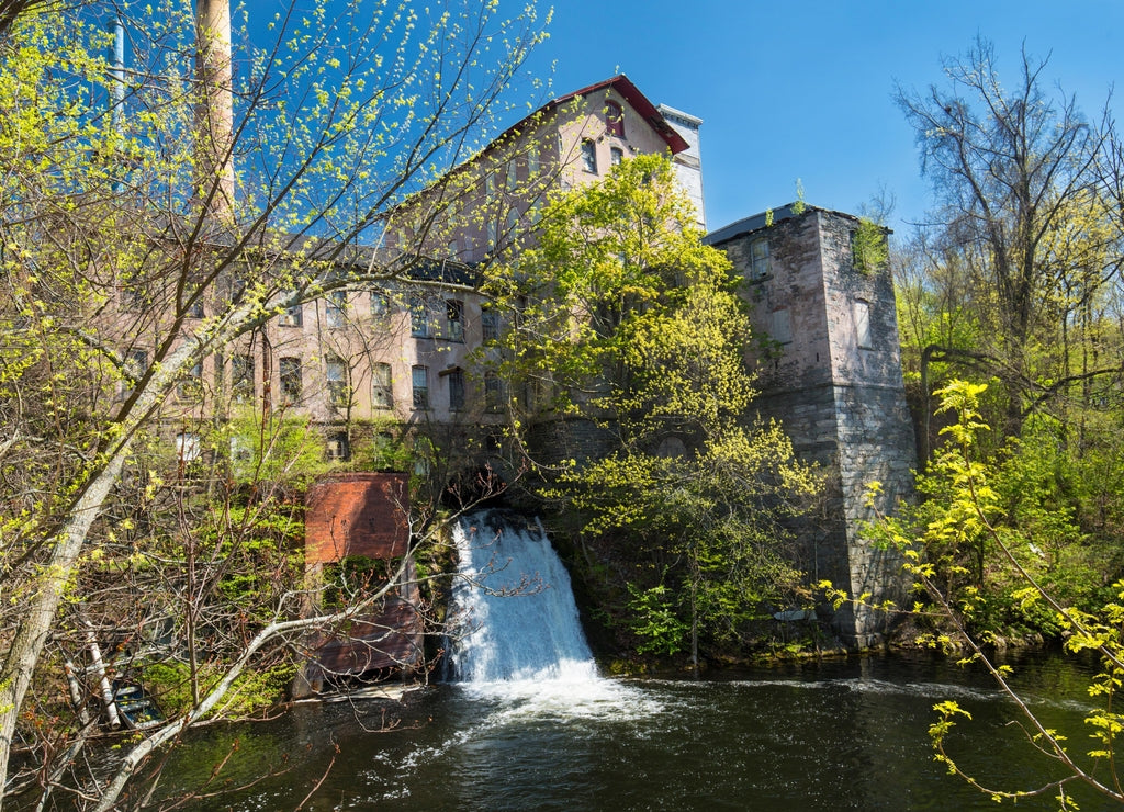Historic, 19th century mill, known as Dart's Stone Mill, with water power sluice on the Hockanum River in Rockville, Connecticut