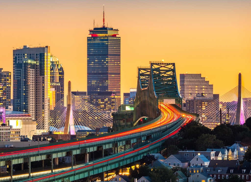 Rush hour traffic on Tobin bridge (aka Mystic River bridge) heading towards Zakim bridge and Boston skyline at sunset