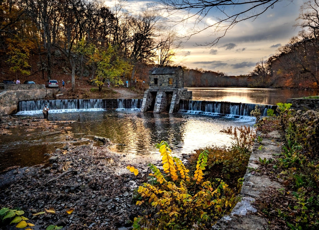 Morristown, New Jersey: An autumnal horizontal wide angle view of New Jersey's historic stone Speedwell Dam during sunset