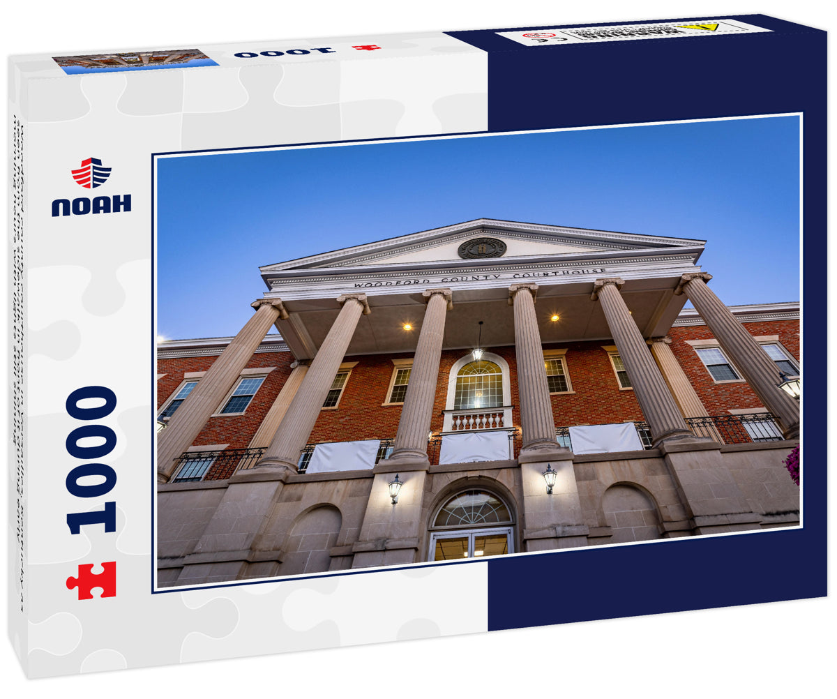 Woodford county courthouse in Versailles, Kentucky as seen from the sidewalk in front of it during early morning hours with lights still shining