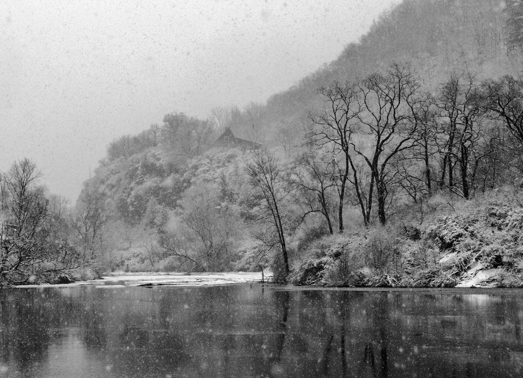 Falling snow creates a pointilistic effect. The Mohawk River funnels through a steep gorge in Little Falls, Herkimer County, New York State, USA