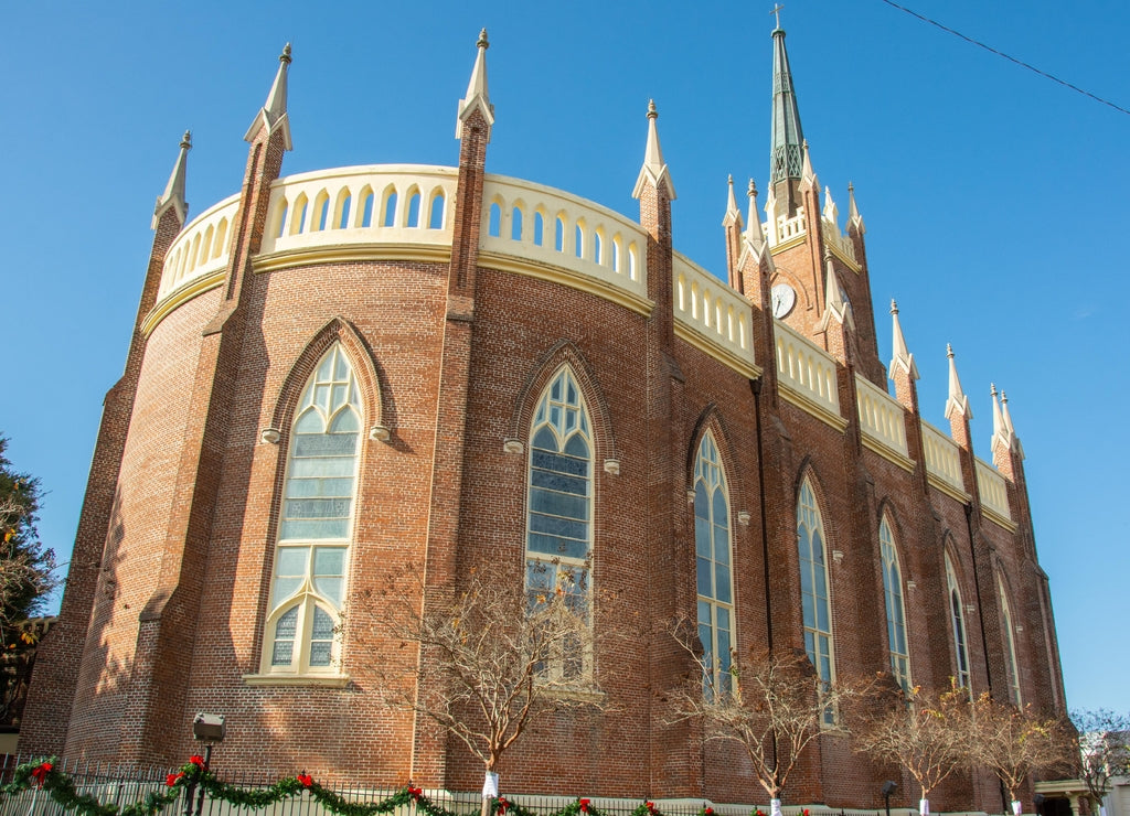 Exterior view of the St. Mary Basilica (Our Lady of Sorrows Cathedral) with semi-circular apsidal end, ornamental pinnacles, and buttresses erected in 1837 in Natchez, Mississippi