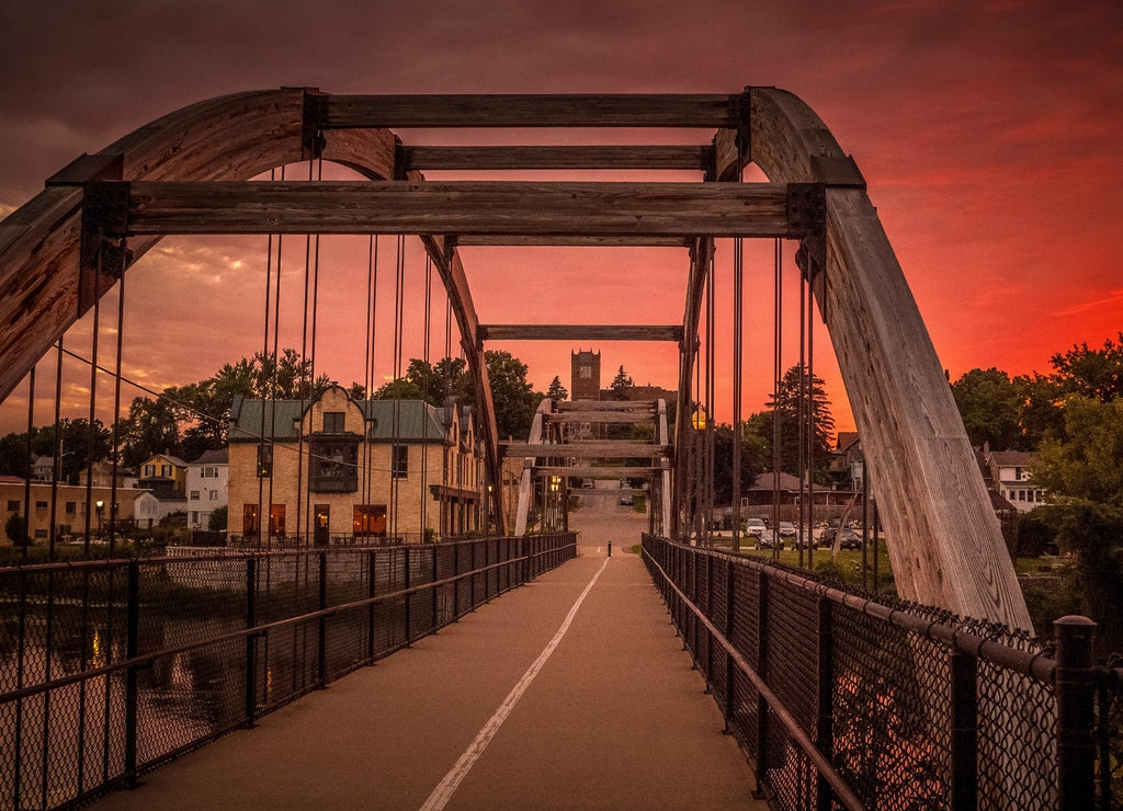 The arched walk bridge in Jefferson, Wisconsin and a red sunset