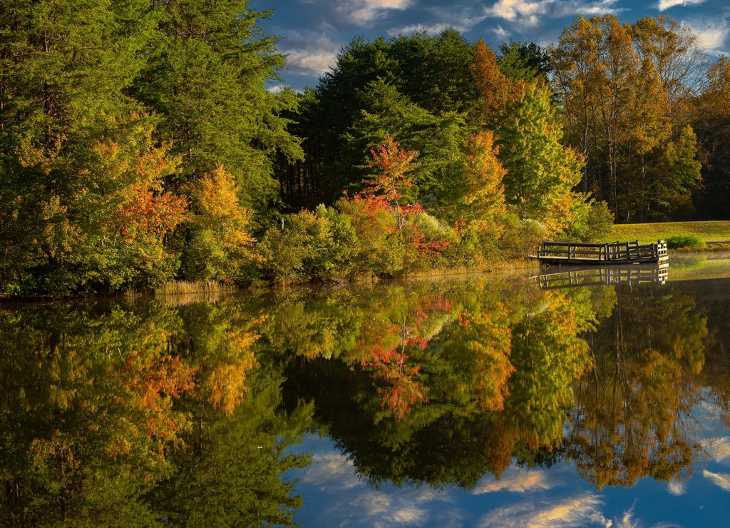 Shorts Lake is surrounded by hardwood trees showing fall color, in Crowders Mountain State park