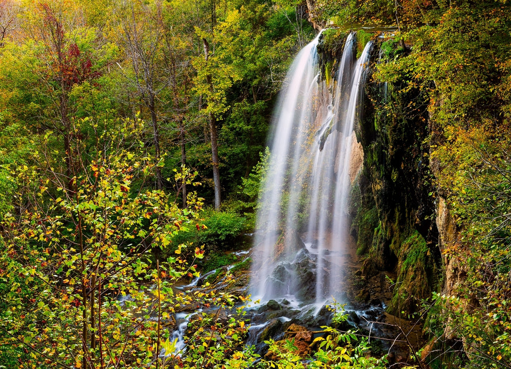 Appalachian mountains long exposure of Falling Spring Waterfall and green yellow forest trees in rural countryside autumn in Covington, Virginia
