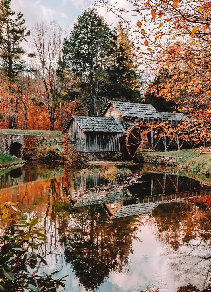 Water reflections of the beautiful Mabry Mill at sunset during the fall - Milepost 176 along the Blue Ridge Parkway in Floyd County, Virginia, USA