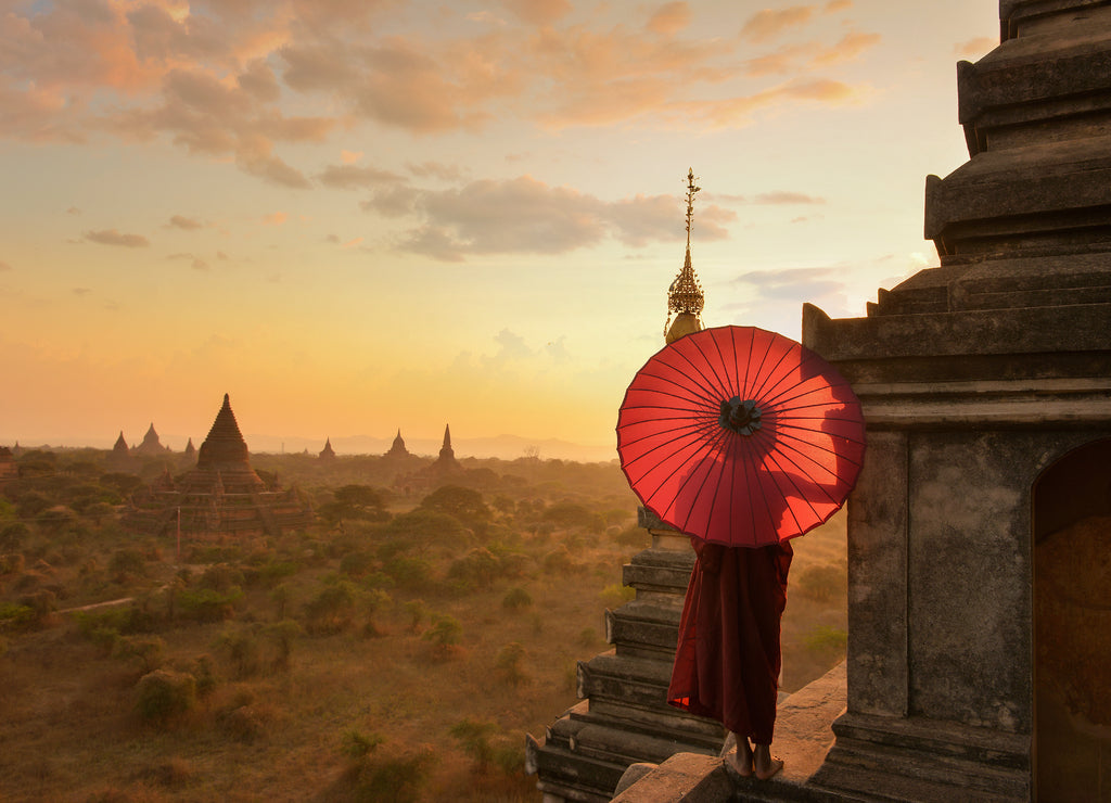 Monk relaxing in ancient temple on during sunset, Bagan Myanmar