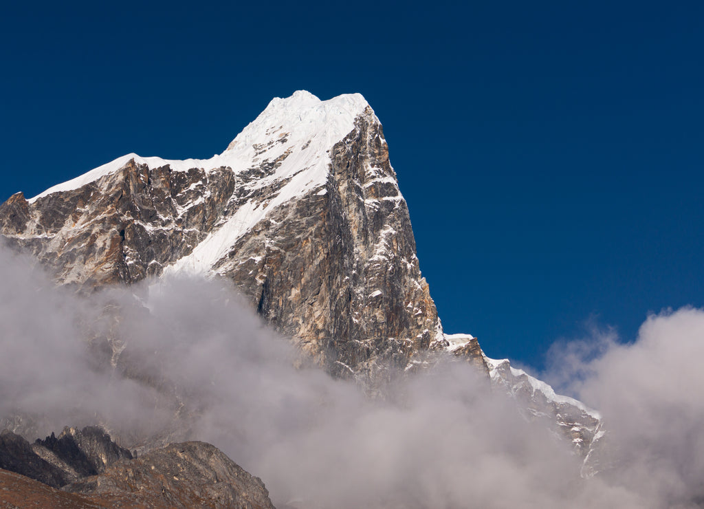 Taboche peak above the clouds view from Dingboche village in Everest base camp trekking route, Himalaya mountains range in Nepal