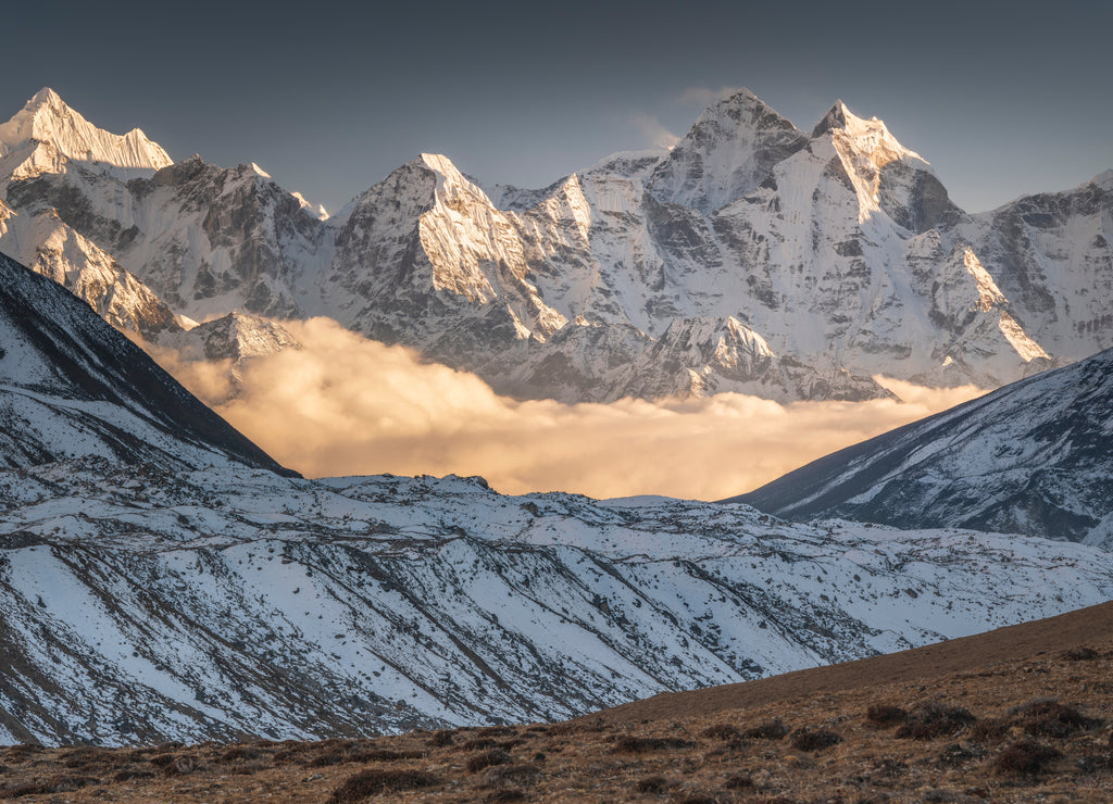 Lighting clouds between snow peaks in valley Khumbu in Nepal