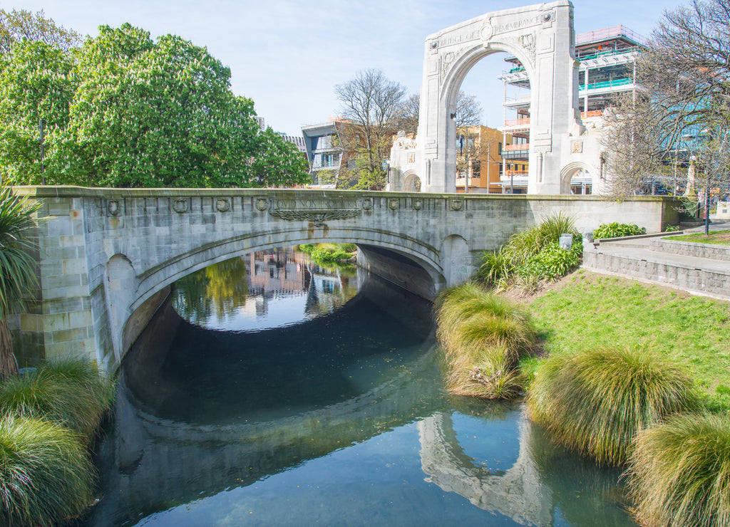 Cityscape of Christchurch downtown and The Bridge of Remembrance reflection on Avon river in Christchurch, New Zealand