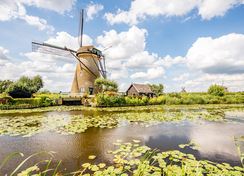 Landscape view on the old windmills during the sunny weather in Kinderdijk village, Netherlands