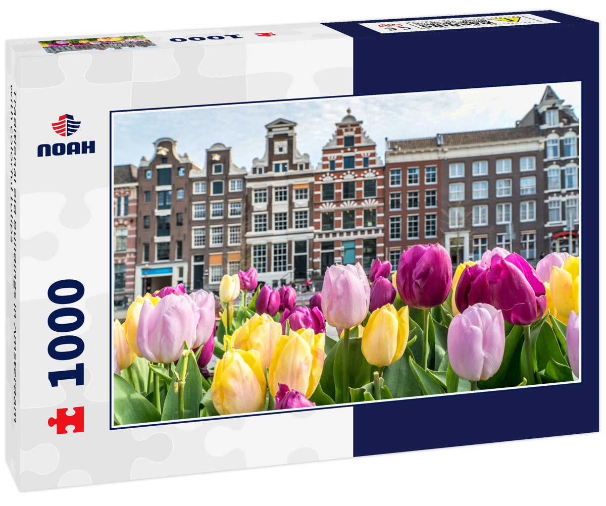 Traditional old buildings in Amsterdam with colorful tulips