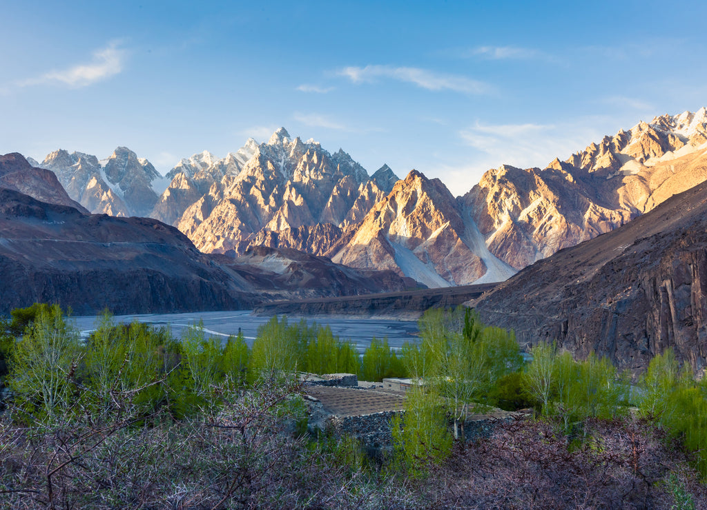 Tupopdan mountain also known as Passu Cones or Passu Cathedral, big rocks all over the place and blue crystal of Hunza river at sunset time, Northern of Pakistan