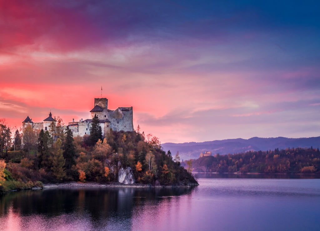 Beautiful castle by the lake at pink dusk, Poland